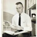 Bill Bryant studying by window.